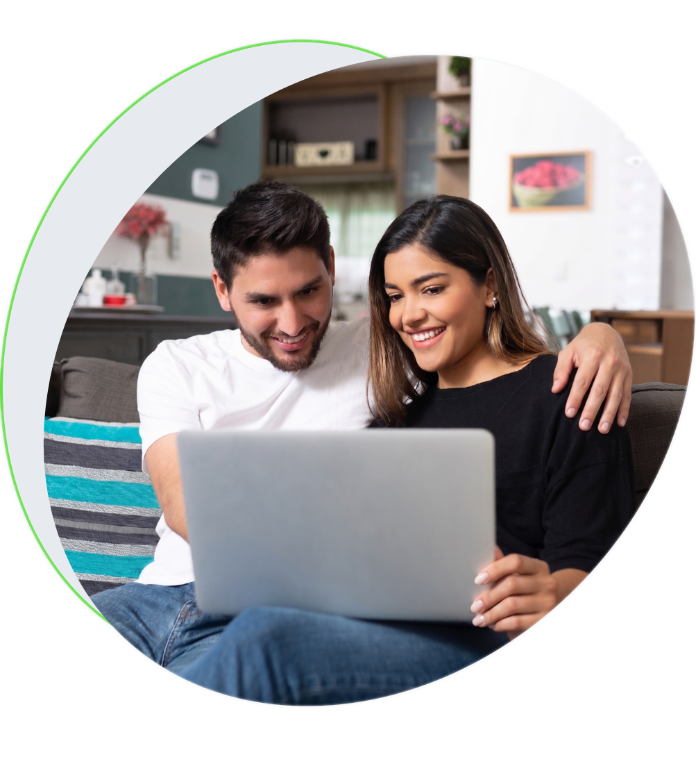 Pareja sonriendo frente a una laptop